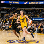 Caitlin Clark driving the basketball down the court in a yellow Indiana Fever jersey during her injury return game against the Los Angeles Sparks.